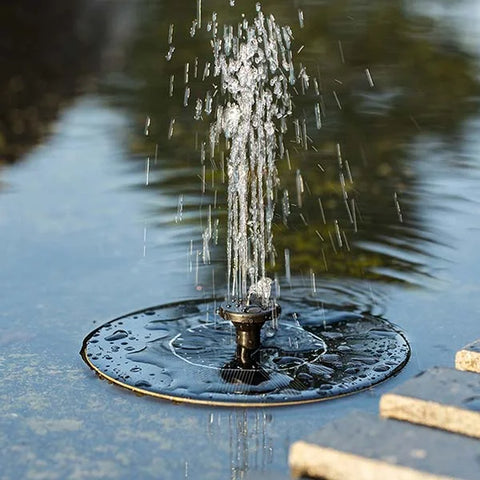 Fountain in a pond with water droplets and reflections
