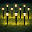 Row of solar garden lights on grass at night