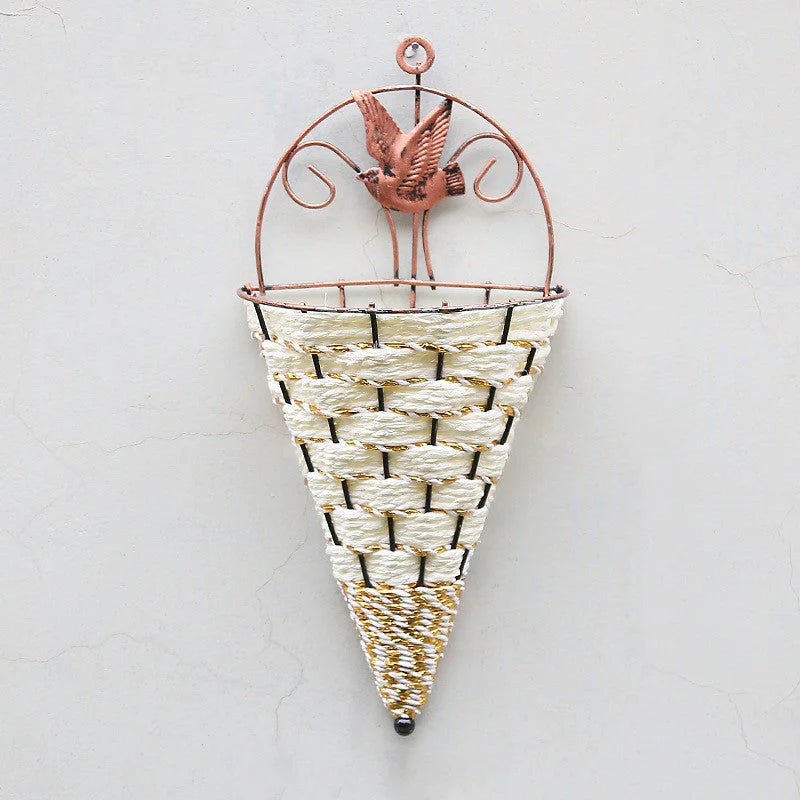 Decorative wall vase with wicker design and metal bird ornament on a white background