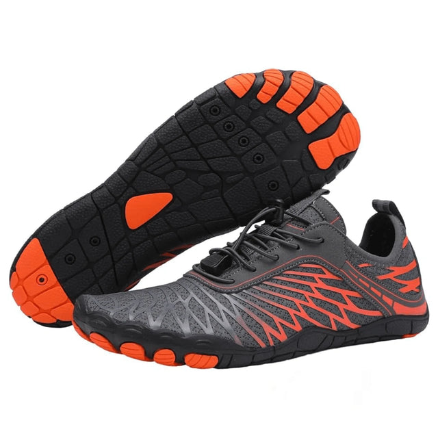 Gray and black athletic shoes with orange accents on a white background