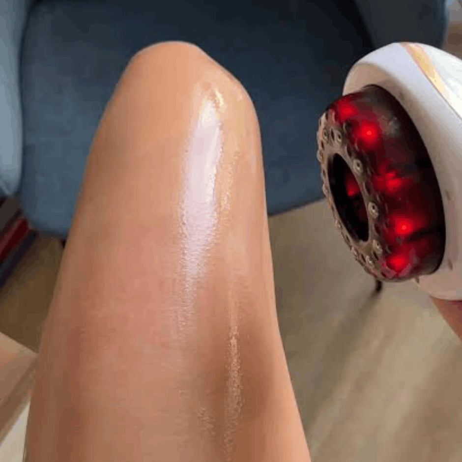 Person using a red light device on their leg