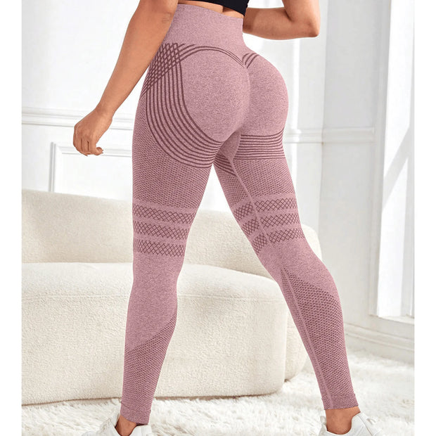 Person wearing pink patterned leggings in a bright room with white furniture.