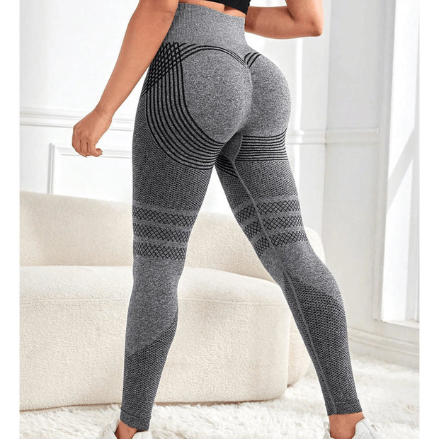 Person wearing gray leggings with a pattern in a bright room