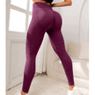 Purple leggings worn by a person in a minimal indoor setting