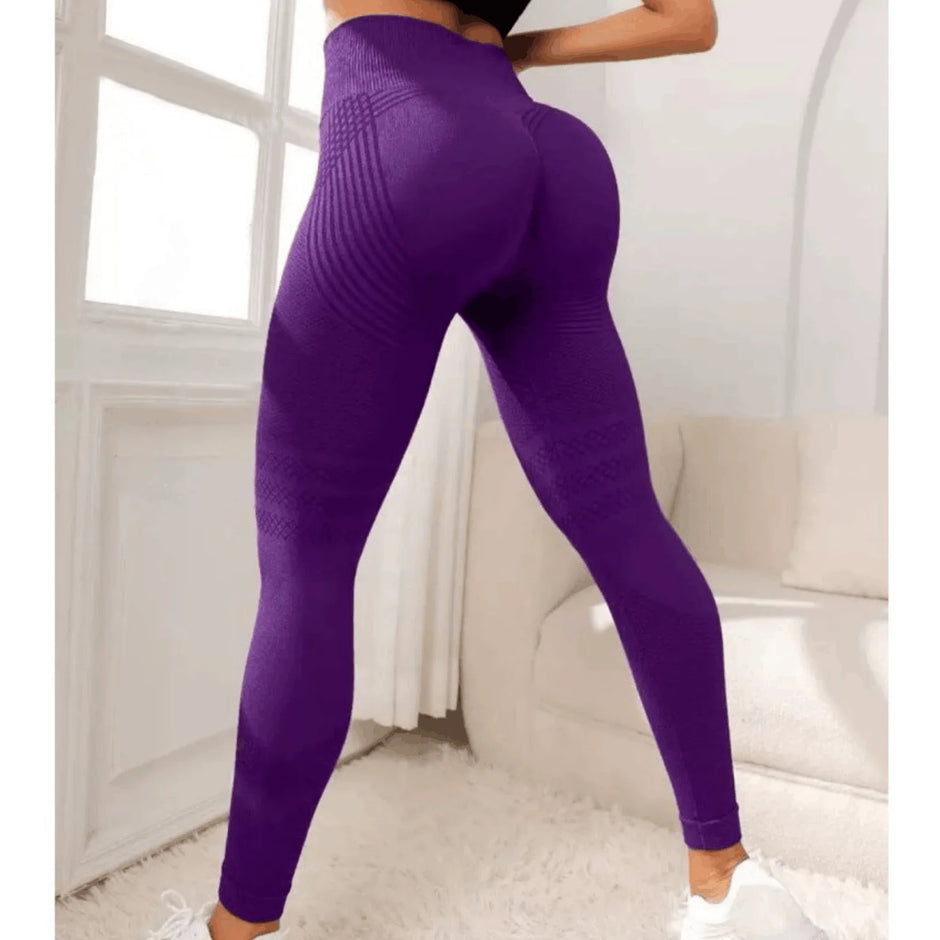 Purple leggings worn by a person in a minimal indoor setting