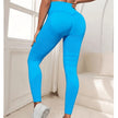 Person wearing bright blue leggings in a minimal indoor setting