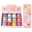 Box of colorful bath bombs with a pink packaging design featuring cartoon animals.