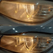 Close-up of a car's headlight with a reflective surface.