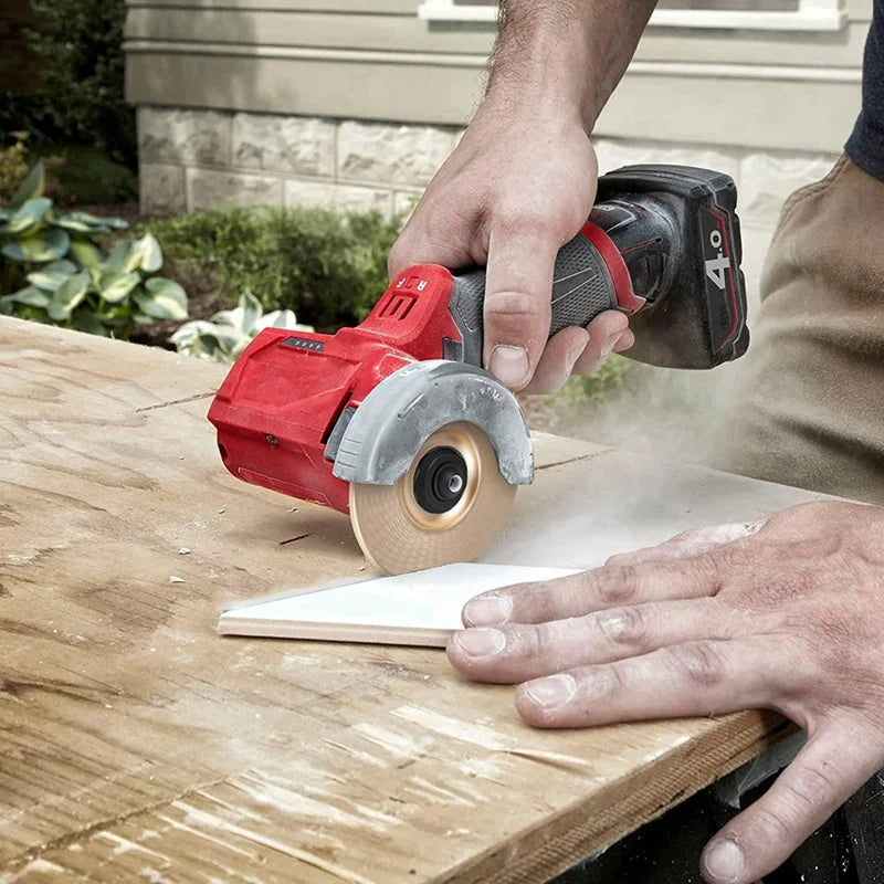 Person using a cordless circular saw to cut wood outdoors