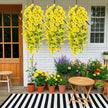 Outdoor patio with yellow floral decorations, potted plants, and a striped rug.