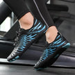Black and blue athletic shoes worn by a person on a treadmill.