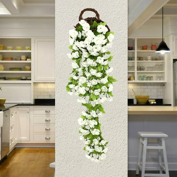 Artificial flower vine hanging on a wall in a kitchen setting