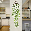 Artificial flower vine hanging on a wall in a kitchen setting