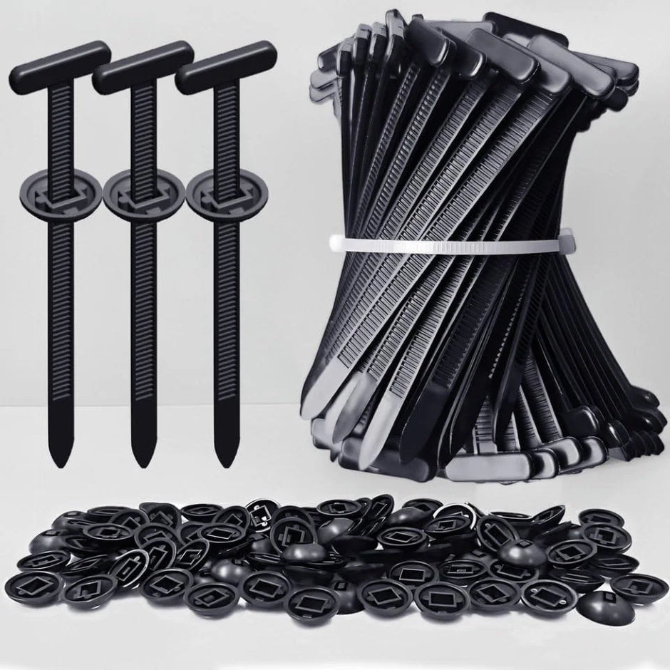 Collection of black plastic clips and fasteners on a white background