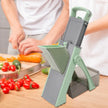 Vegetable chopper on a kitchen counter with vegetables and a person chopping.