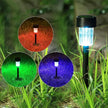 Solar-powered garden light with color-changing capabilities in grass