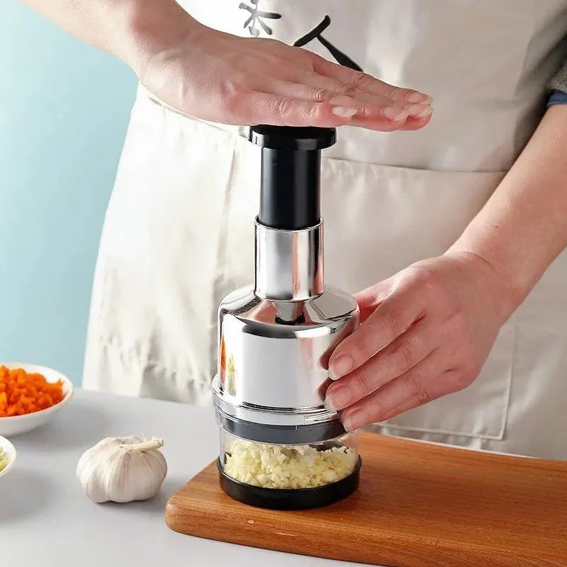 Person using a garlic press on a wooden cutting board with ingredients in the background.