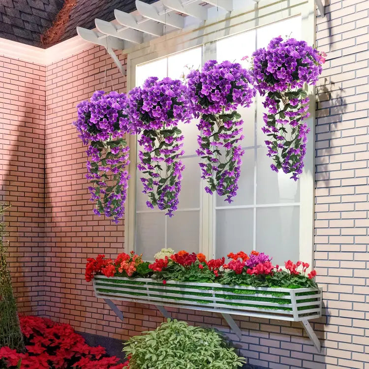 Window box with purple and red flowers against a brick wall