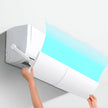 Person adjusting a wall-mounted air conditioner with a blue light effect