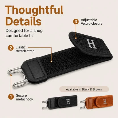 Black strap with adjustable velcro closure, elastic stretch strap, and metal hook on a beige background.
