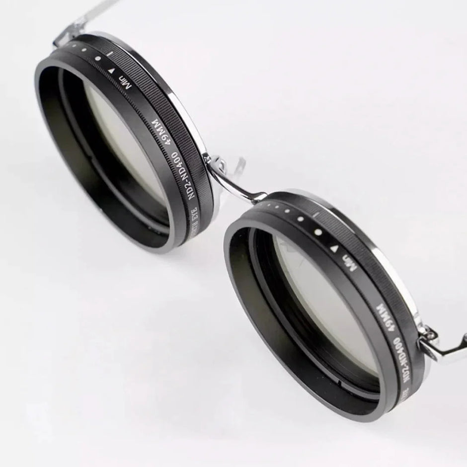 Two black camera lens filters with metal frames on a white background