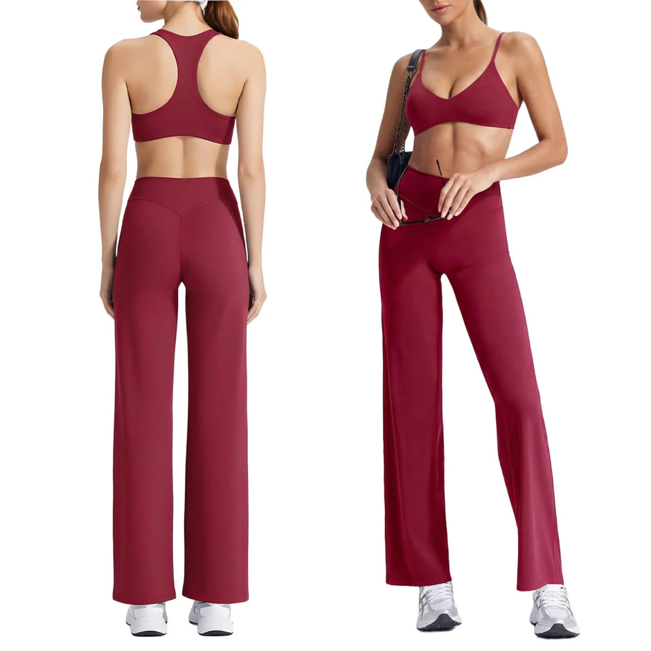Woman wearing a red sports bra and leggings set on a white background