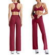 Woman wearing a red sports bra and leggings set on a white background
