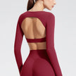 Maroon long-sleeve top with cut-out design on a plain background