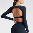 Black long-sleeve top with cut-out design on a plain background