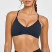 Woman wearing a black bikini top against a white background