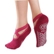 Pink yoga socks with a white design on a white background