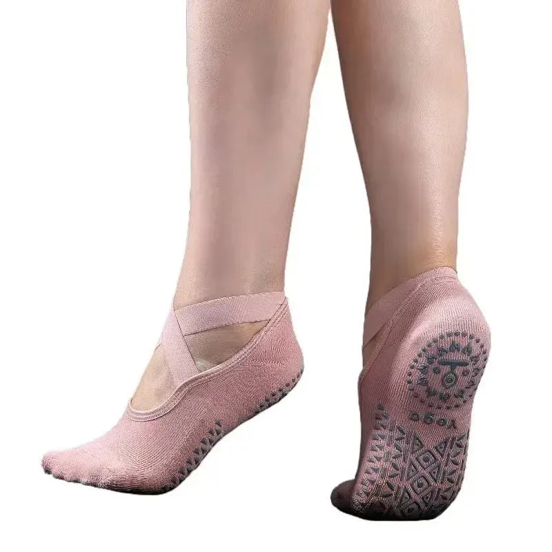 Pink yoga socks with non-slip sole on a white background