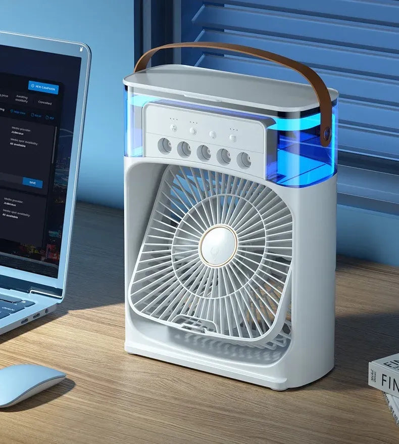 Portable fan on a desk next to a laptop with a blue gradient background