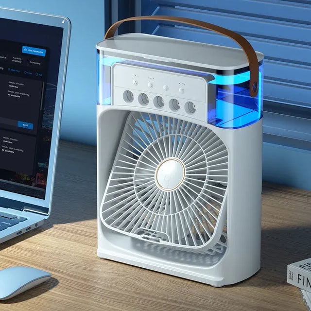 Portable fan on a desk next to a laptop with a blue gradient background