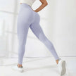 Person wearing light purple leggings on a white background