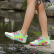 Colorful water shoes worn by a person standing on a rock with a natural background