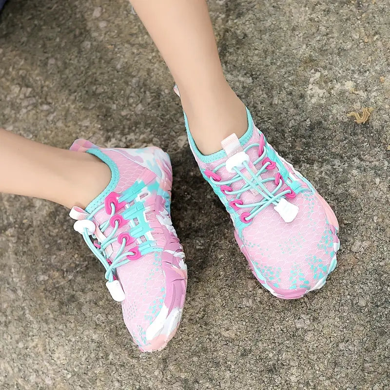 Pink and blue athletic shoes on a concrete surface
