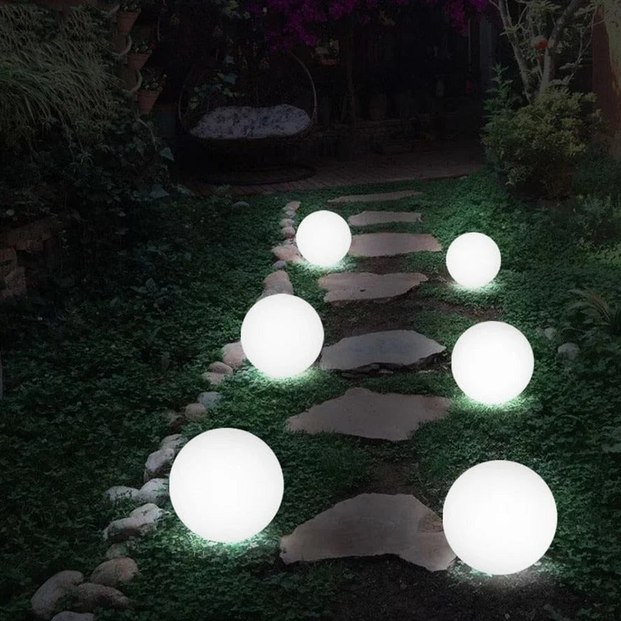 Glowing spherical solar lights on a garden path