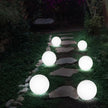 Glowing spherical solar lights on a garden path
