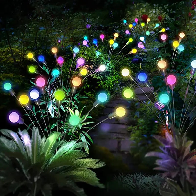 Colorful garden lights on stakes in a garden setting