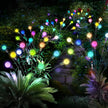 Colorful garden lights on stakes in a garden setting