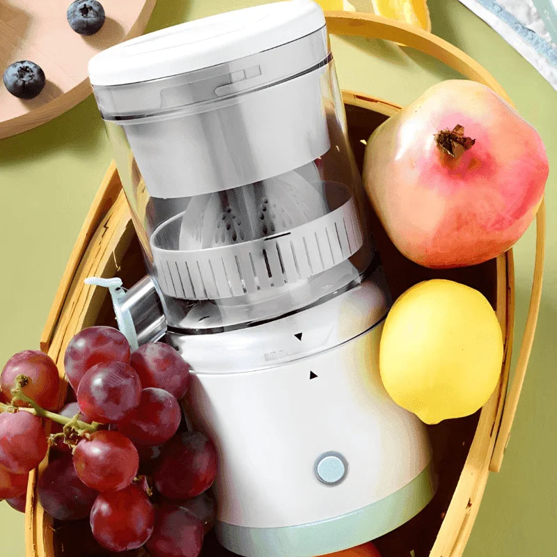 White juicer with fruits like grapes, apple, and lemon on a green background