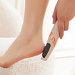 Person using a foot scrubber on their foot with a blurred background