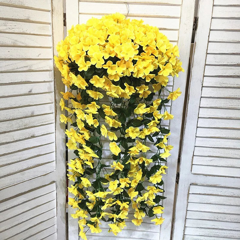 Yellow artificial flower vine hanging on a white wooden door