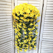Yellow artificial flower vine hanging on a white wooden door