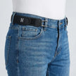 Blue jeans with a black belt featuring a logo on a white background