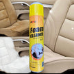 Foam cleaner spray can for car and house cleaning on a beige car seat background