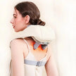 Woman using a neck and shoulder massager with glowing orange lights on a plain background