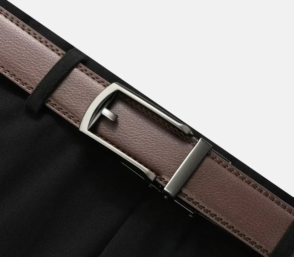 Brown leather belt with silver buckle on a black background