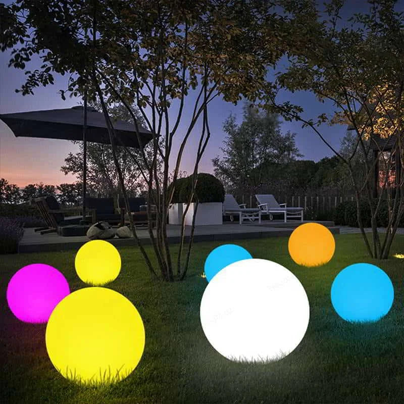 Colorful LED light balls on grass with outdoor setting